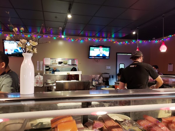 a restaurant buffet counter with people and food